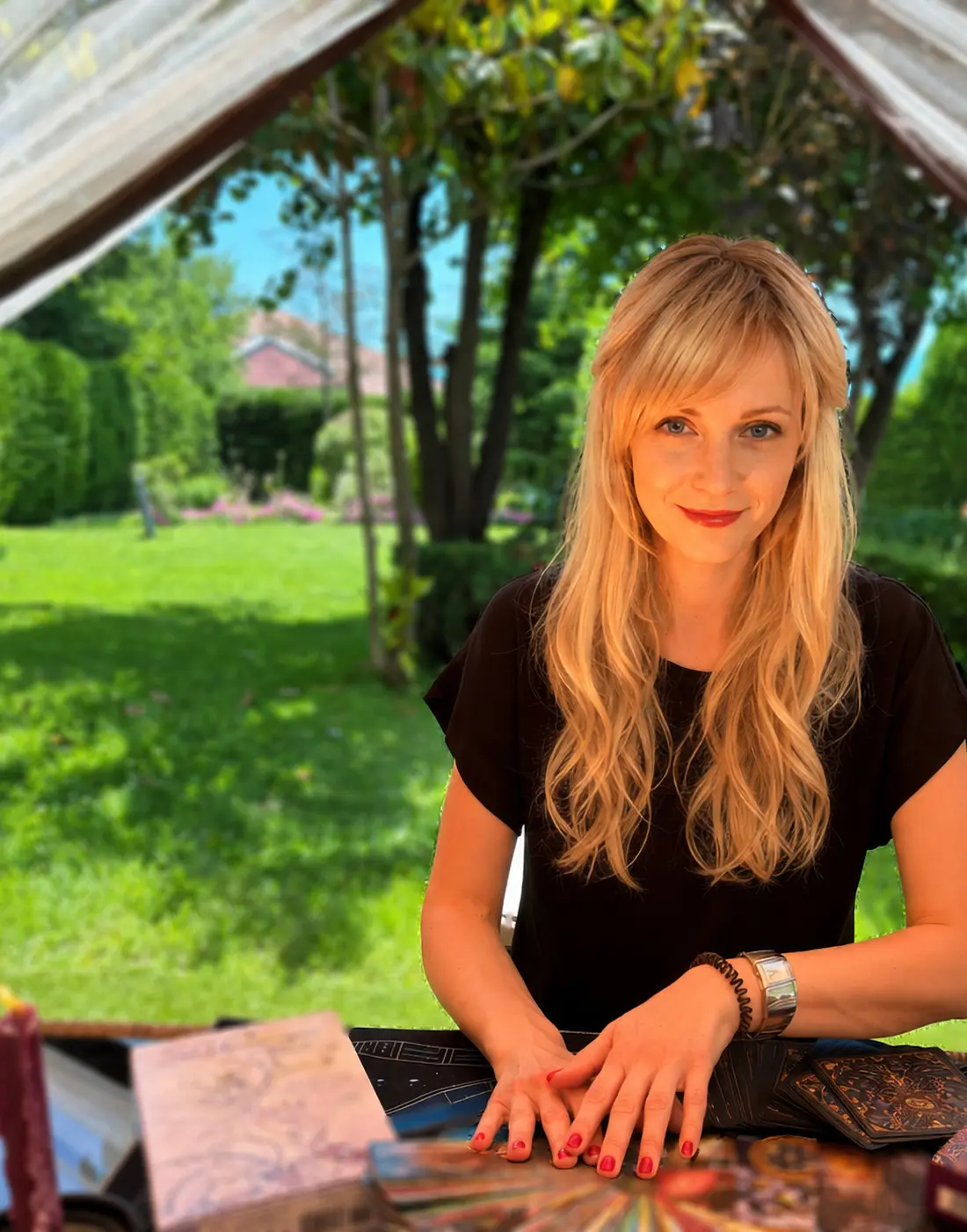 Angela seated at her tarot reading table